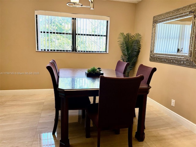 dining room featuring light tile patterned floors and baseboards