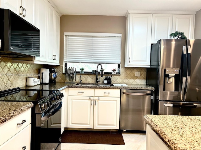 kitchen with black appliances, white cabinetry, backsplash, and a sink