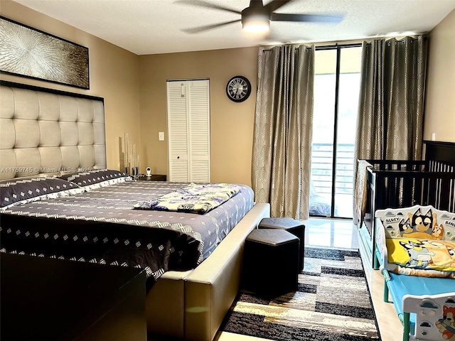 bedroom with ceiling fan and a textured ceiling