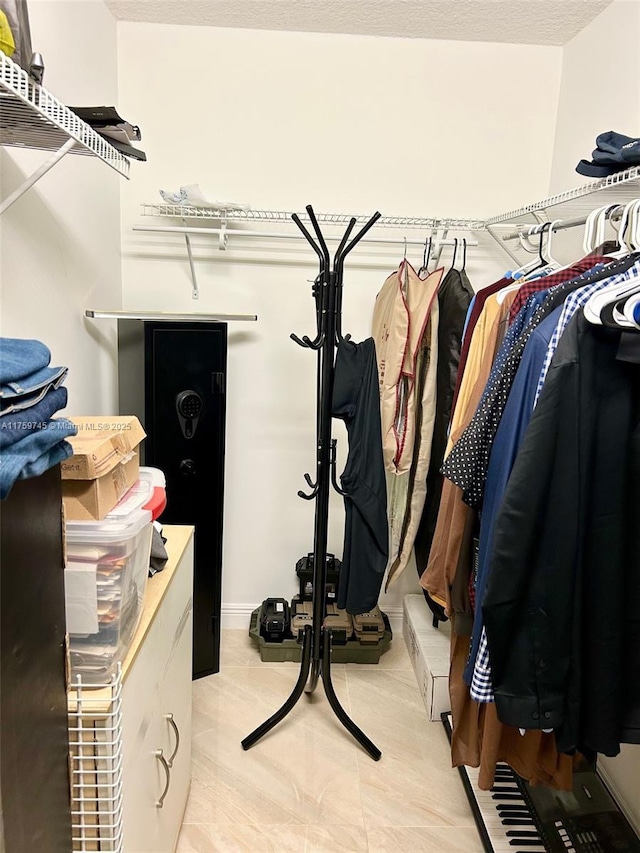 walk in closet featuring light tile patterned floors