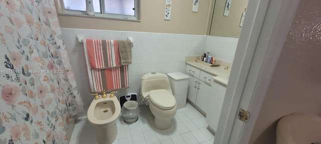 bathroom with toilet, tile patterned floors, curtained shower, a bidet, and tile walls