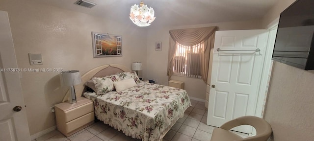 bedroom featuring light tile patterned floors, baseboards, visible vents, and a notable chandelier