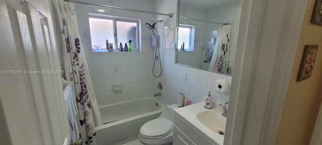 full bathroom featuring toilet, vanity, and shower / tub combo with curtain