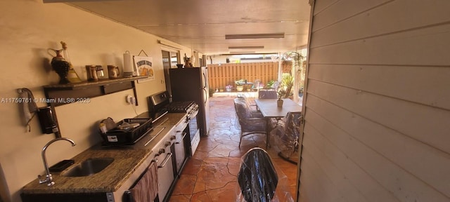 interior space featuring stone finish floor and a sink