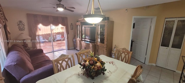 dining area featuring light tile patterned floors and a ceiling fan