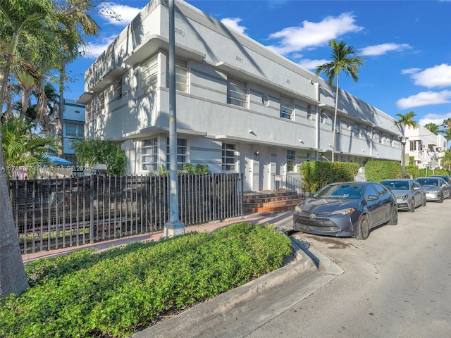 view of building exterior featuring fence