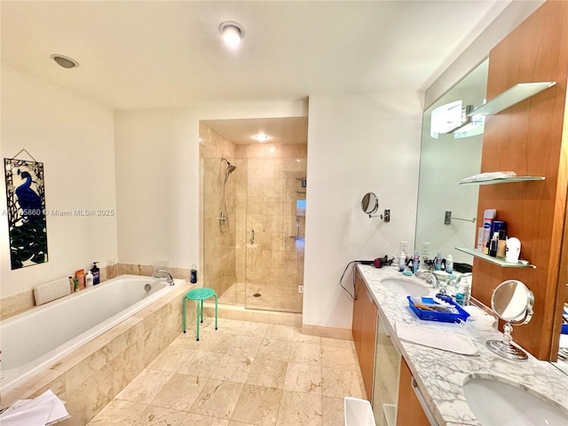 bathroom featuring double vanity, a stall shower, baseboards, a garden tub, and a sink