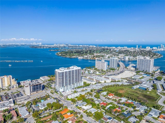 drone / aerial view featuring a water view and a view of city