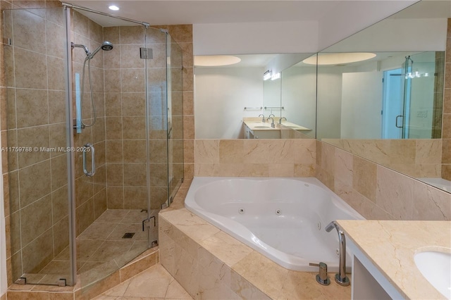 bathroom with a whirlpool tub, a shower stall, and vanity