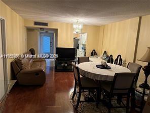 dining area featuring dark wood-style flooring