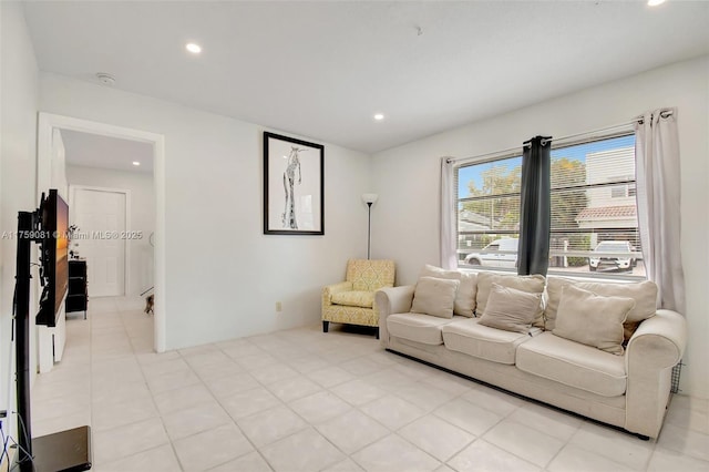 tiled living area featuring recessed lighting