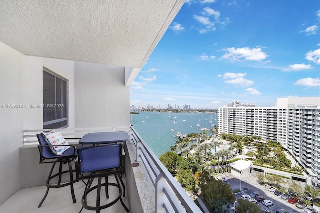 balcony with a water view and a city view