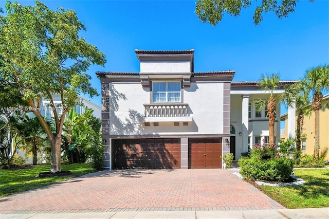 4951 SW 158th Ave, Miramar, FL 33027 - mediterranean / spanish-style home featuring stucco siding, a garage, decorative driveway, and a tile roof