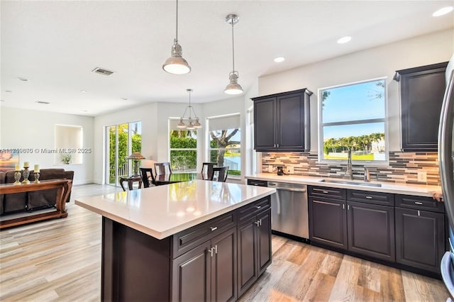4951 SW 158th Ave, Miramar, FL 33027 - kitchen with stainless steel dishwasher, light countertops, decorative backsplash, light wood-style floors, and recessed lighting