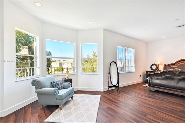 sitting room with baseboards, wood finished floors, and recessed lighting