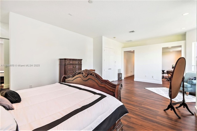 bedroom with dark wood-style floors, baseboards, visible vents, and recessed lighting