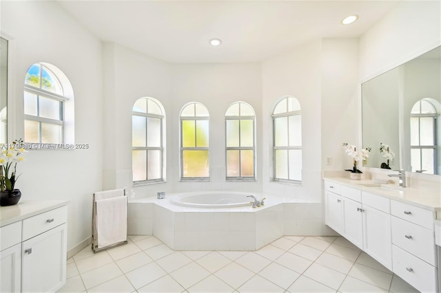 bathroom with recessed lighting, tile patterned flooring, a bath, and vanity