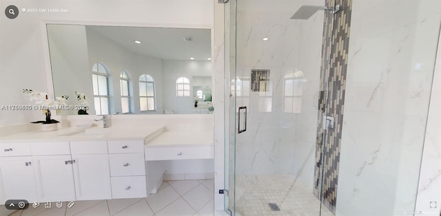 full bath featuring a marble finish shower, visible vents, and vanity