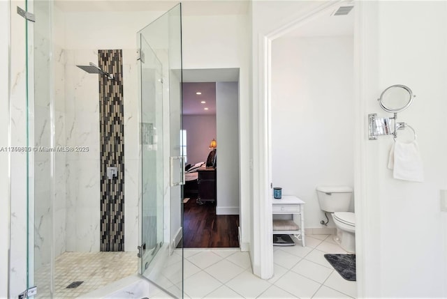 ensuite bathroom featuring tile patterned flooring, toilet, connected bathroom, and a marble finish shower