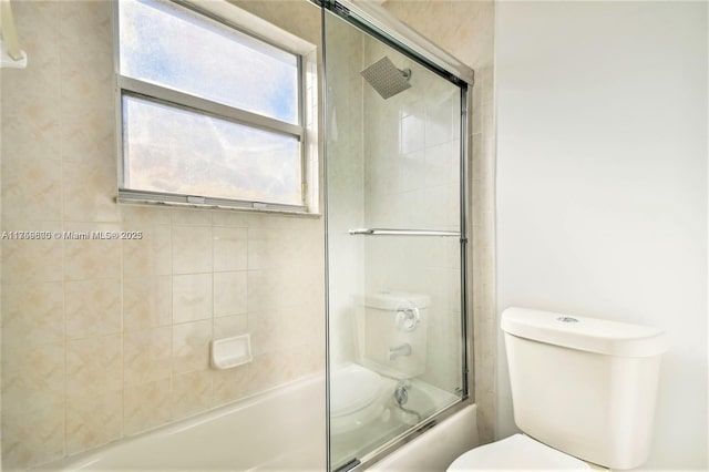 full bath featuring enclosed tub / shower combo and toilet