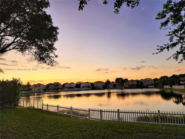 water view featuring a residential view and fence