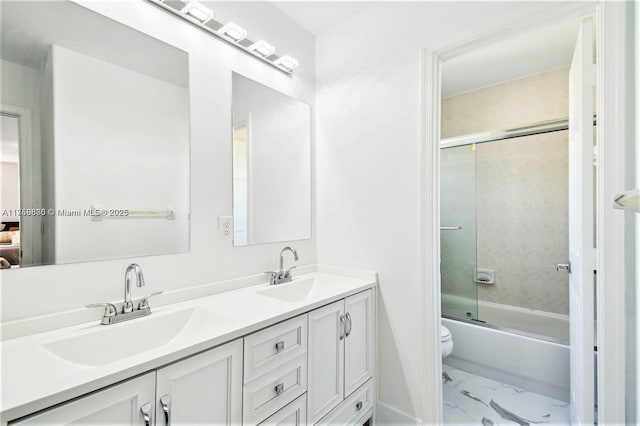 4951 SW 158th Ave, Miramar, FL 33027 - bathroom featuring marble look tiles, double vanity, and enclosed tub / shower combo