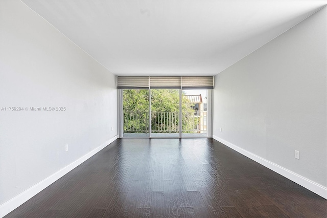 unfurnished room featuring a wall of windows, baseboards, and dark wood-style flooring