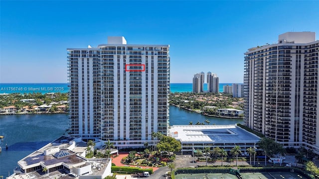 birds eye view of property with a water view and a city view