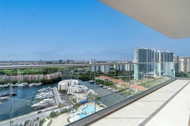 balcony with a water view and a view of city