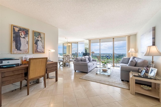 living room featuring a wealth of natural light, floor to ceiling windows, a textured ceiling, and an inviting chandelier