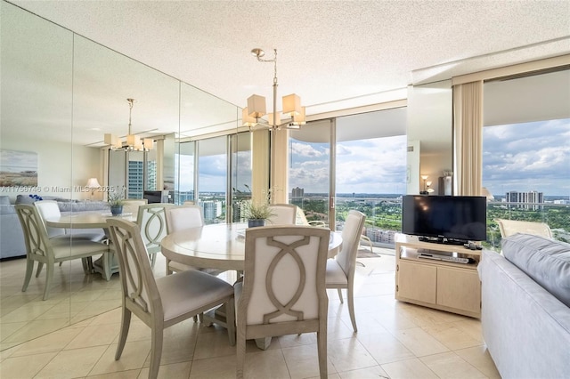 dining area with light tile patterned floors, floor to ceiling windows, a chandelier, and a textured ceiling