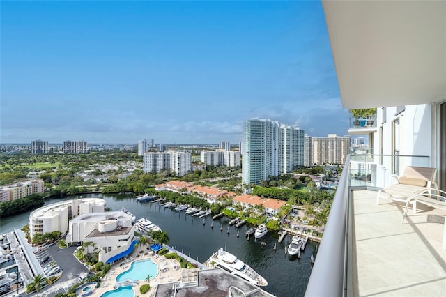 balcony featuring a water view and a city view