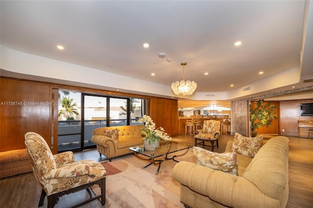 living room with light wood-type flooring, visible vents, and recessed lighting