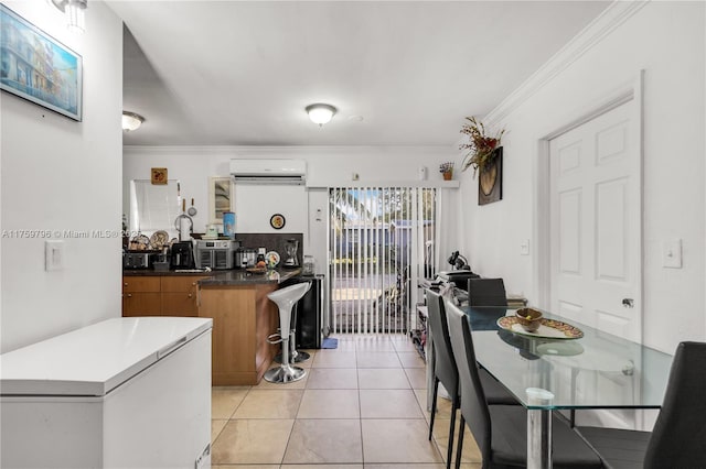 dining room featuring light tile patterned floors, ornamental molding, and a wall mounted AC