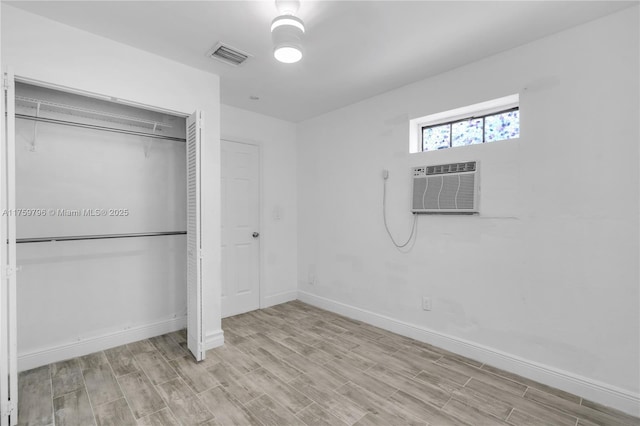 2810 NW 171st Ter, Miami Gardens, FL 33056 - unfurnished bedroom featuring a closet, wood finished floors, and an AC wall unit
