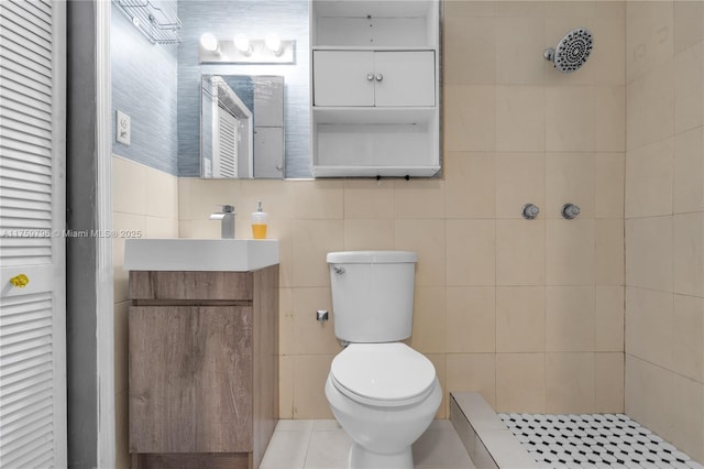2810 NW 171st Ter, Miami Gardens, FL 33056 - full bathroom featuring a tile shower, vanity, tile walls, and tile patterned floors