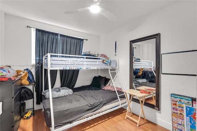 bedroom with a ceiling fan and wood finished floors