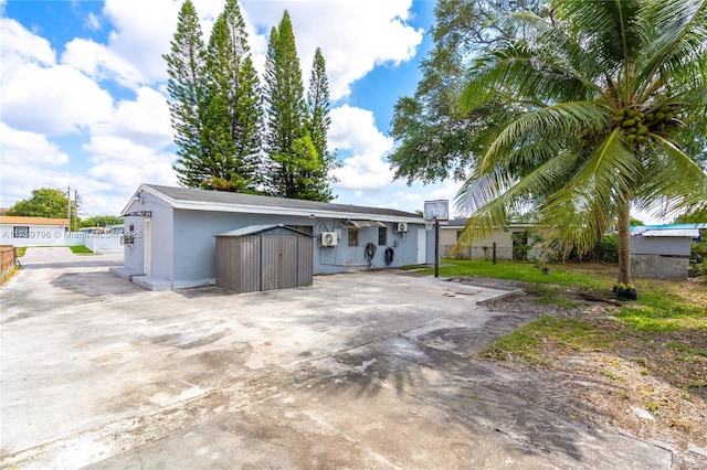 2810 NW 171st Ter, Miami Gardens, FL 33056 - view of front of property with a storage unit, driveway, and stucco siding