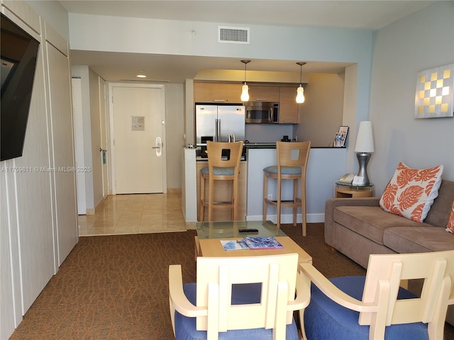 carpeted living room featuring visible vents and tile patterned floors