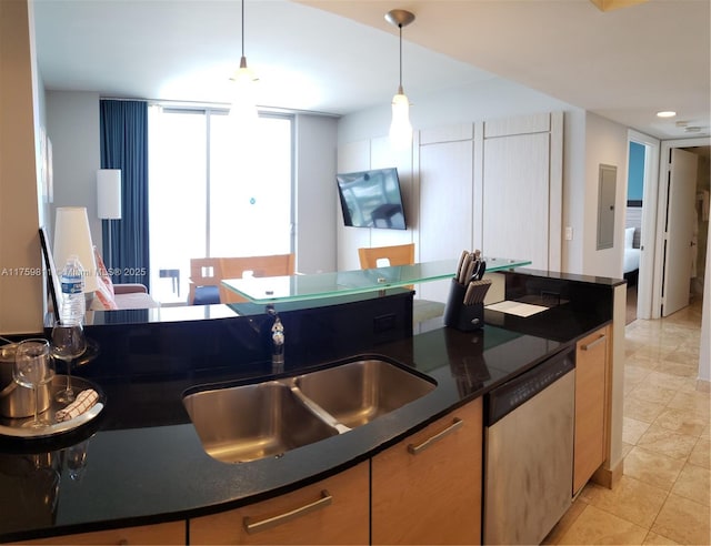 kitchen featuring floor to ceiling windows, light tile patterned floors, hanging light fixtures, a sink, and dishwasher