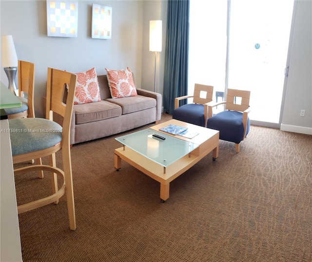 living room featuring carpet and baseboards