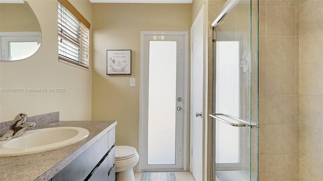 bathroom with vanity, a shower stall, and toilet