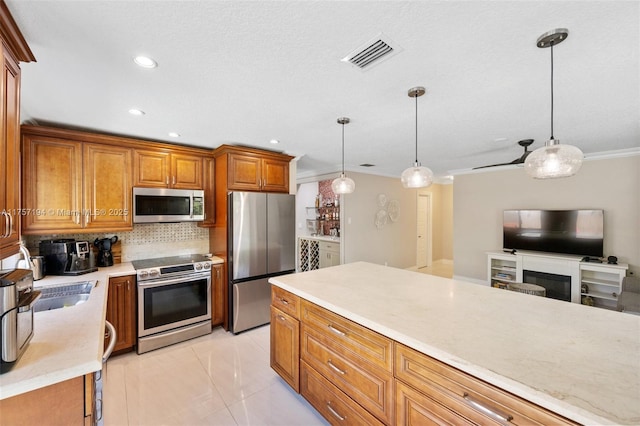 17 Boxwood Rd, Hollywood, FL 33021 - kitchen featuring visible vents, stainless steel appliances, decorative backsplash, light countertops, and brown cabinets
