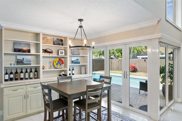 17 Boxwood Rd, Hollywood, FL 33021 - dining space featuring ornamental molding, a notable chandelier, french doors, and a textured ceiling