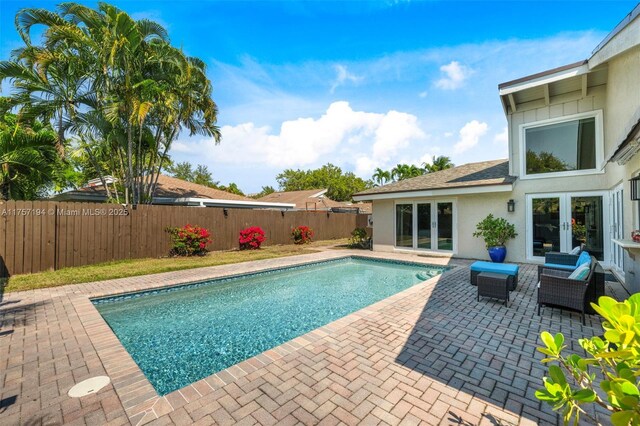 17 Boxwood Rd, Hollywood, FL 33021 - view of swimming pool featuring french doors, a fenced in pool, a fenced backyard, and a patio area