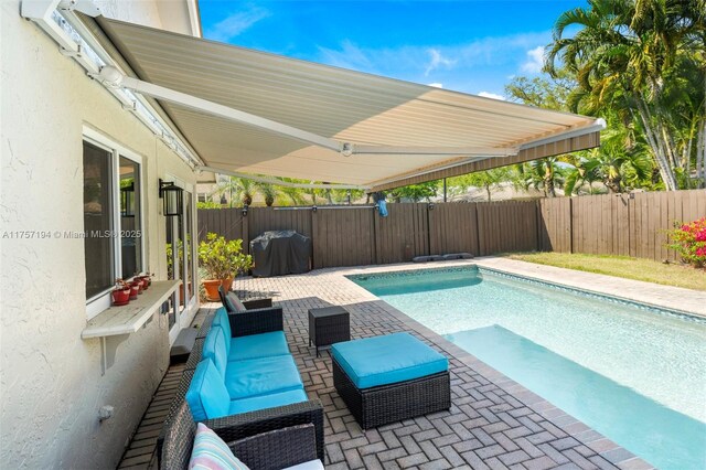 17 Boxwood Rd, Hollywood, FL 33021 - view of swimming pool with a fenced in pool, a patio, area for grilling, and a fenced backyard