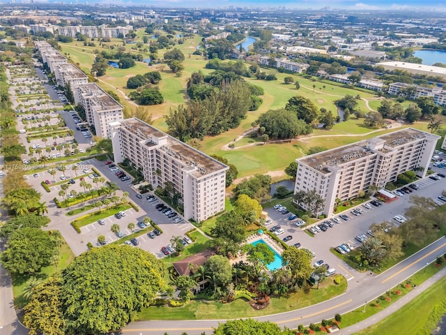 birds eye view of property with a view of city, a water view, and view of golf course