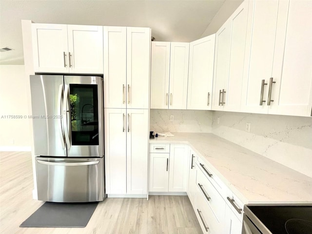 kitchen featuring light stone counters, tasteful backsplash, smart refrigerator, light wood-style floors, and white cabinets