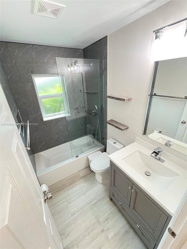 full bathroom featuring visible vents, vanity, toilet, and bathing tub / shower combination