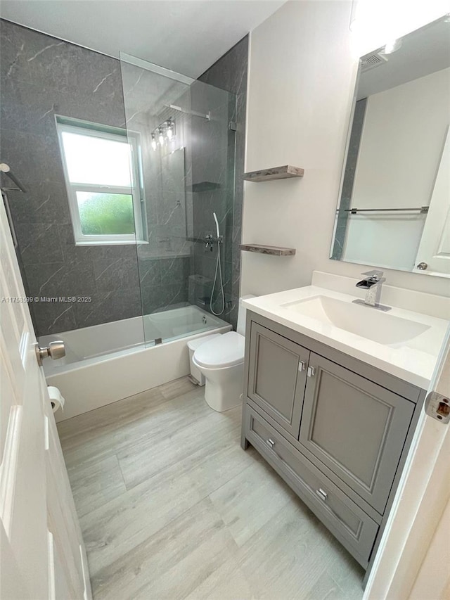 full bathroom with bathtub / shower combination, visible vents, vanity, and toilet